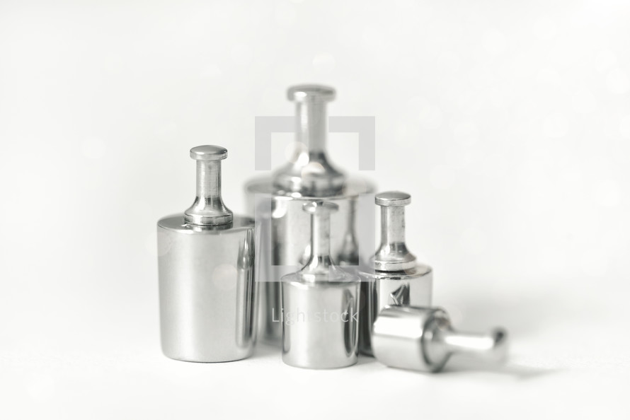 Set of metal weights for scales on white background