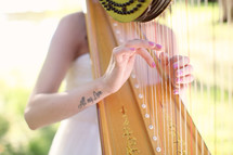 a woman playing a harp at a wedding 