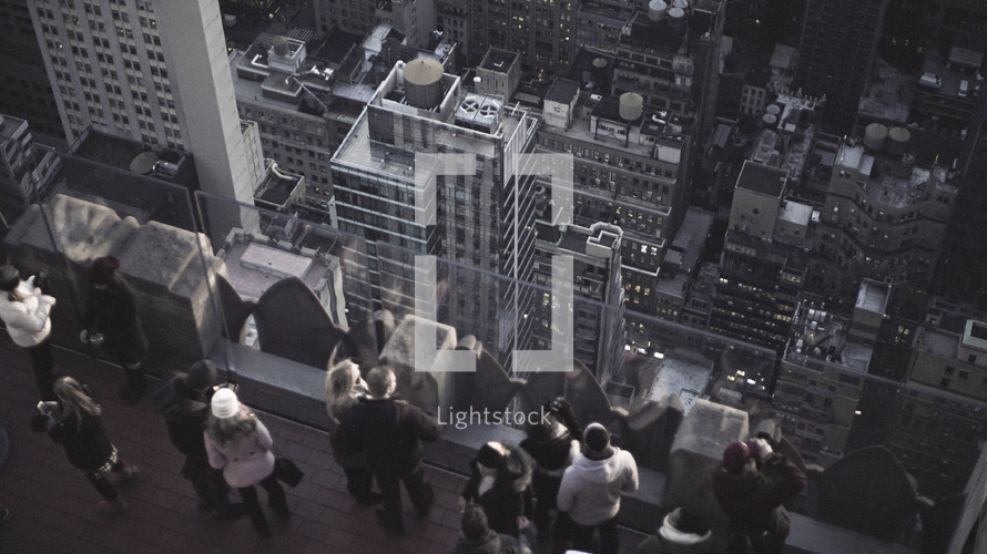 people on a skyscraper balcony in New York City 