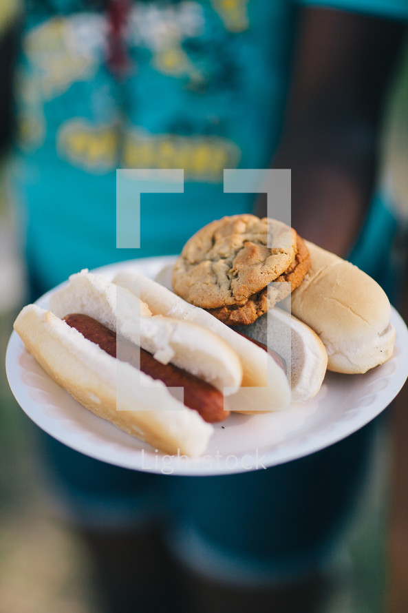 cookies and hot dogs on a plate 