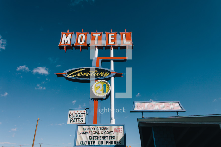 motel sign against a blue sky 