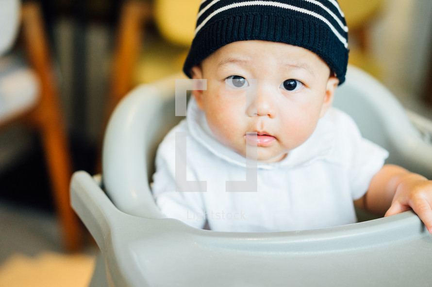 infant in a high chair 