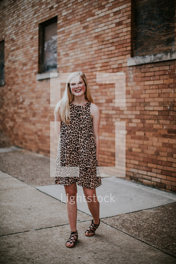 teen girl in a leopard print dress