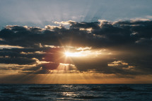 sunburst and sunlight through the clouds over the ocean 