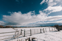 fence and snow on farmland 