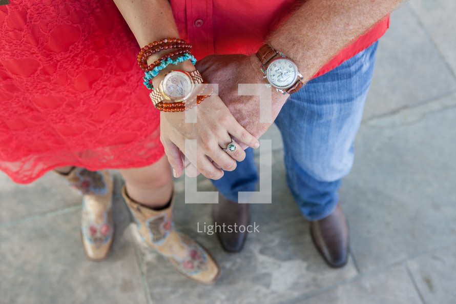 couple, from waist down, holding hands
