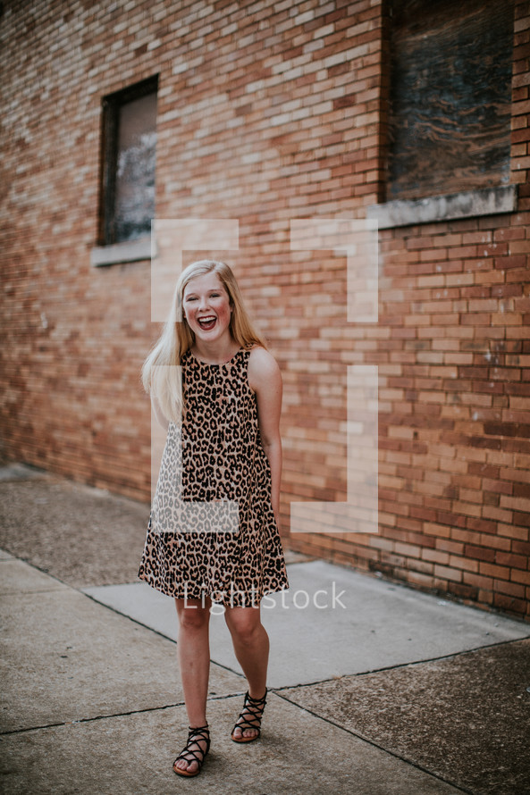 happy teen girl in a leopard print dress