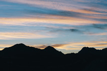 silhouette of a mountain range at sunset 