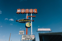 motel sign against a blue sky 