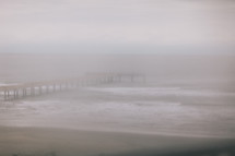fog over a beach pier 