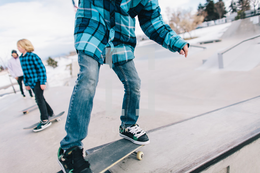 teen boys on skateboards at a skate park 