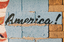 word America painting on a brick wall 