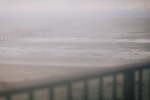 fog over a beach and pier 