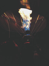 flames on a hot air balloon in darkness 