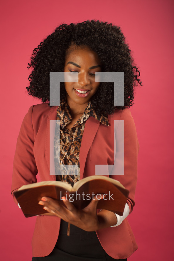an African American woman reading a Bible 