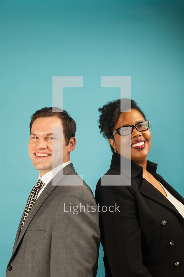 businessman and businesswoman standing back to back 