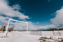 entrance to a ranch in snow 