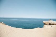 sea cliffs and sand along a coastline 