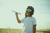 a child with a paper airplane 