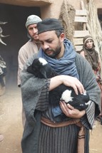 man holding a goat in biblical times 