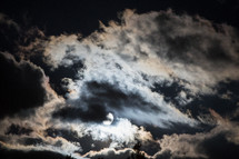 a moon and clouds in the sky 