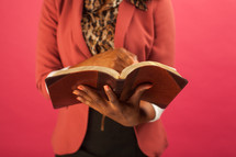 torso of a woman reading a Bible 