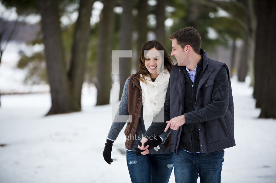 couple walking outdoors in the snow 