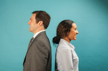 businesswoman and businessman standing back to back 