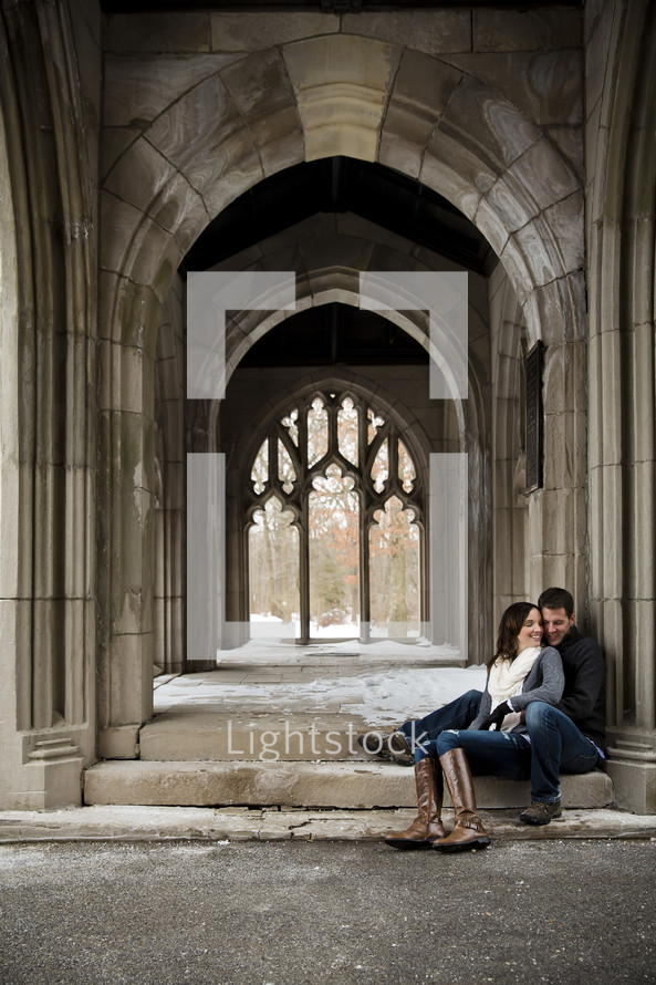 couple sitting on steps to a Cathedral 