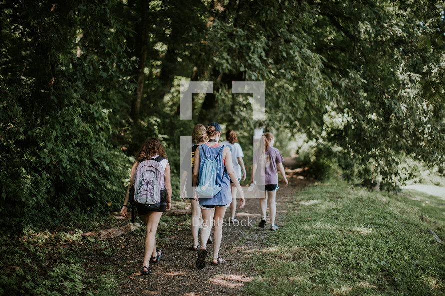teen girls hiking on a path 