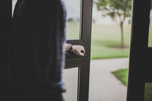 man holding open a door 