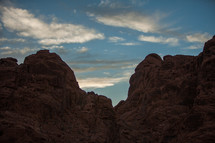 red rock cliffs and clouds in a blue sky 