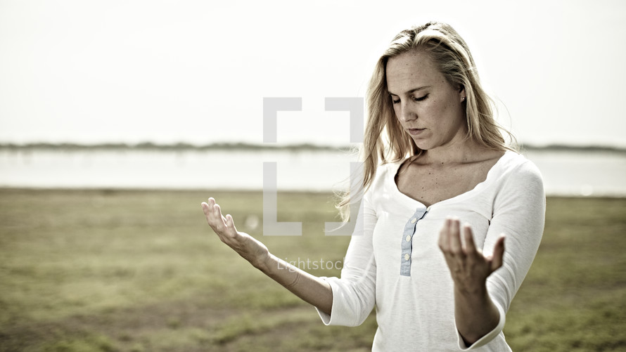 A woman with arms extended - praying