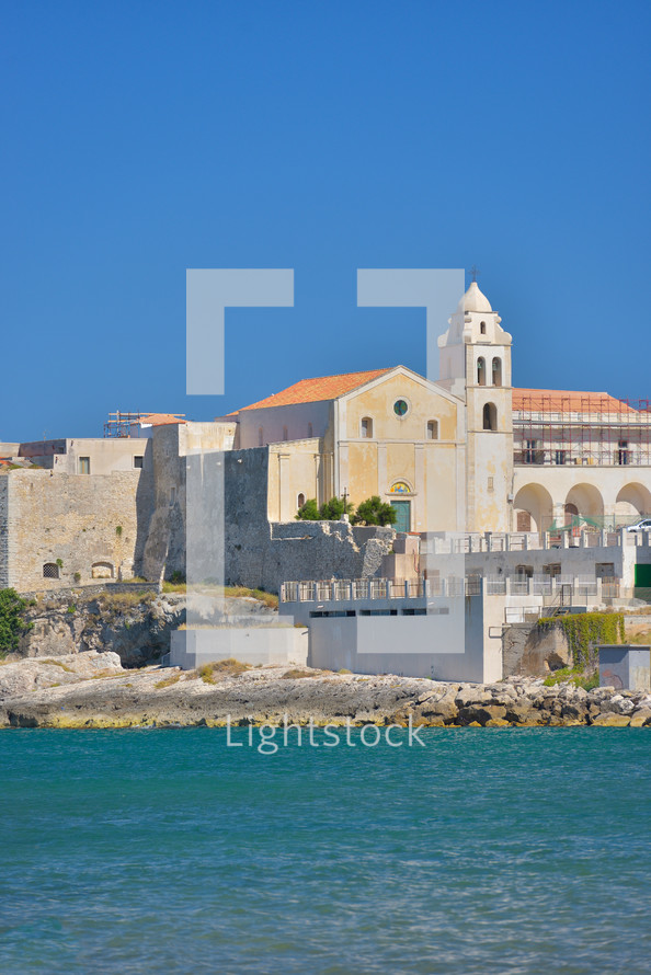 View at the houses from the coast of Vieste on a sunny day, Puglia region, Italy 
