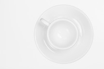 white cup and saucer on a white background. 