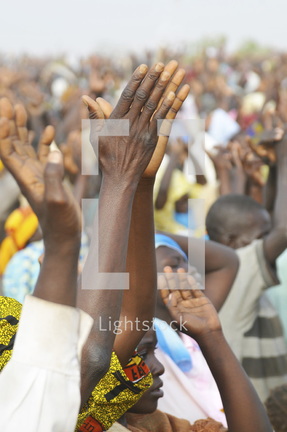 Crowd of Nigerian's lifting their hands in worship