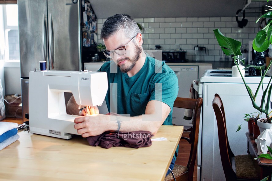 a man using a sewing machine 