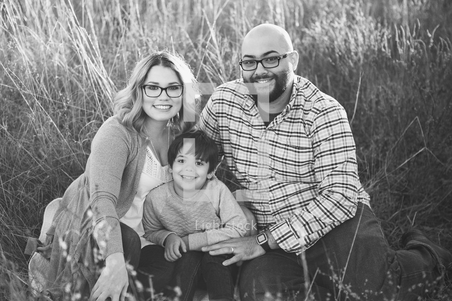 family portrait in a field of tall grasses