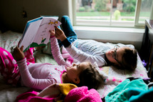 sisters reading in bed 