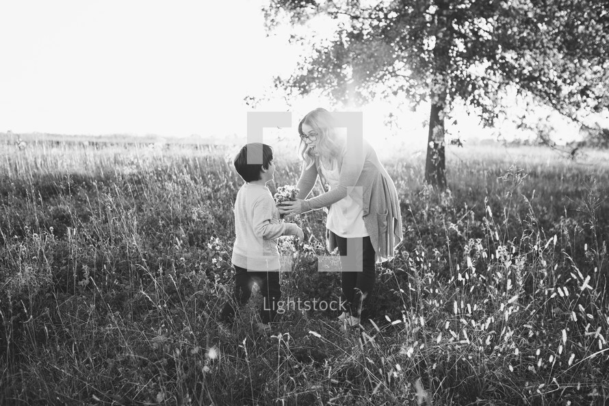 mother and son in a field of tall grasses 