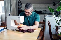 a man using a sewing machine 