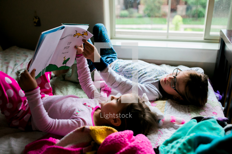 sisters reading in bed 