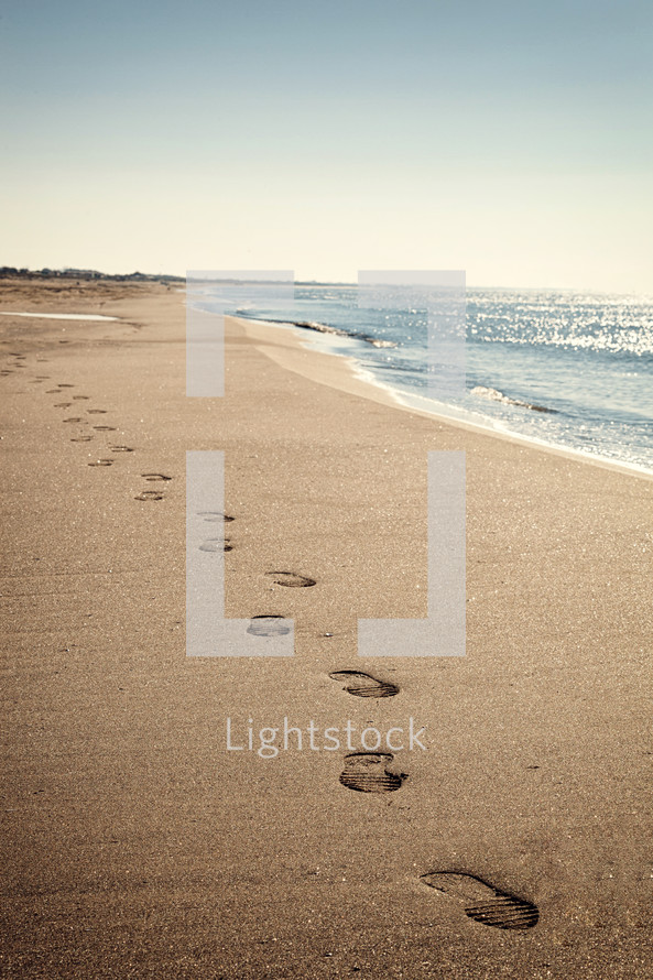 footprints on a beach 