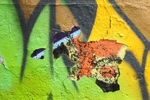 peeling paint on a graffiti covered wall