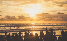 crowded beach at sunset 