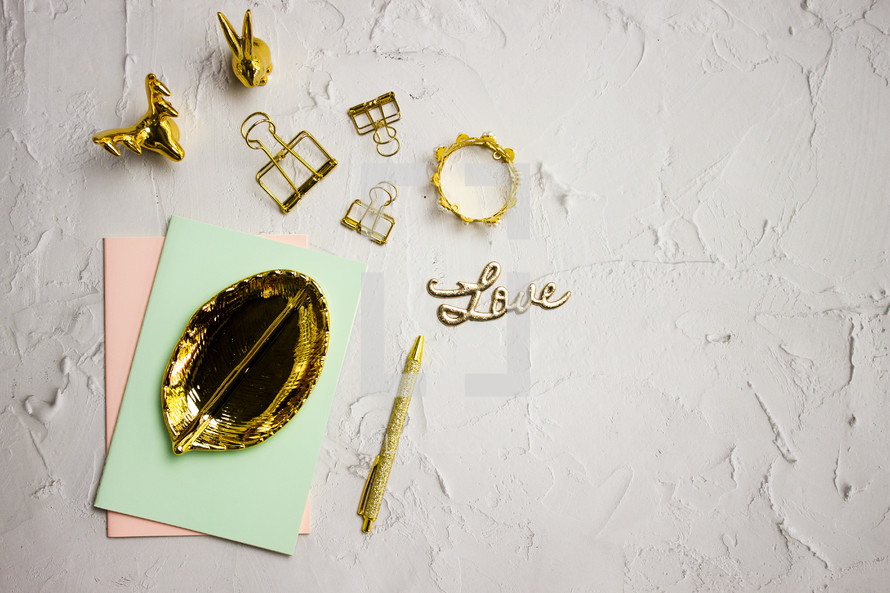 gold trinkets on a desk 