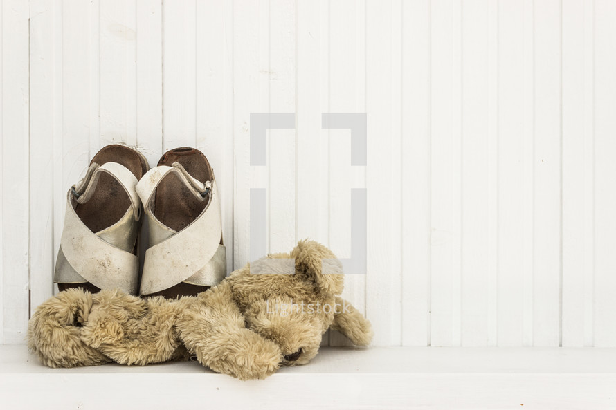 teddy bear and child's sandals 