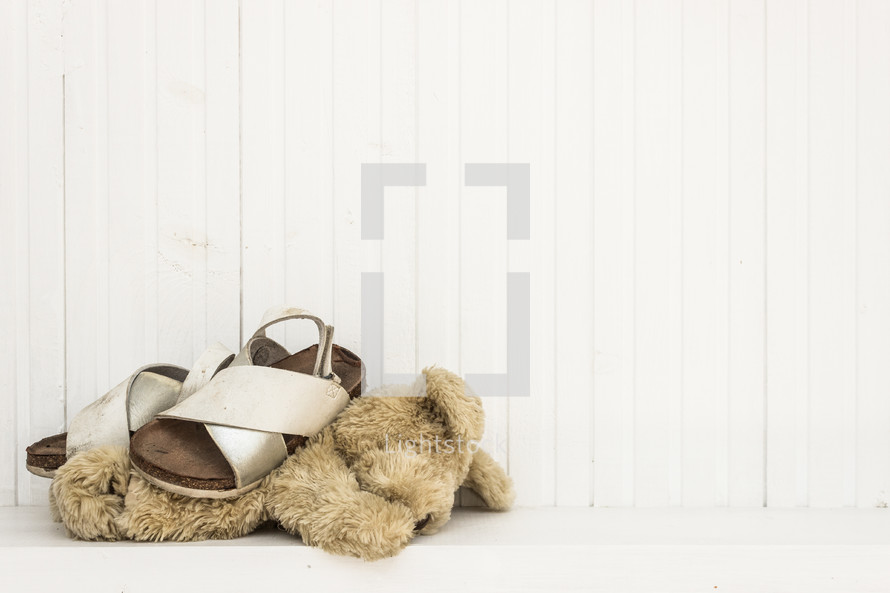 child's sandals and lost teddy bear
