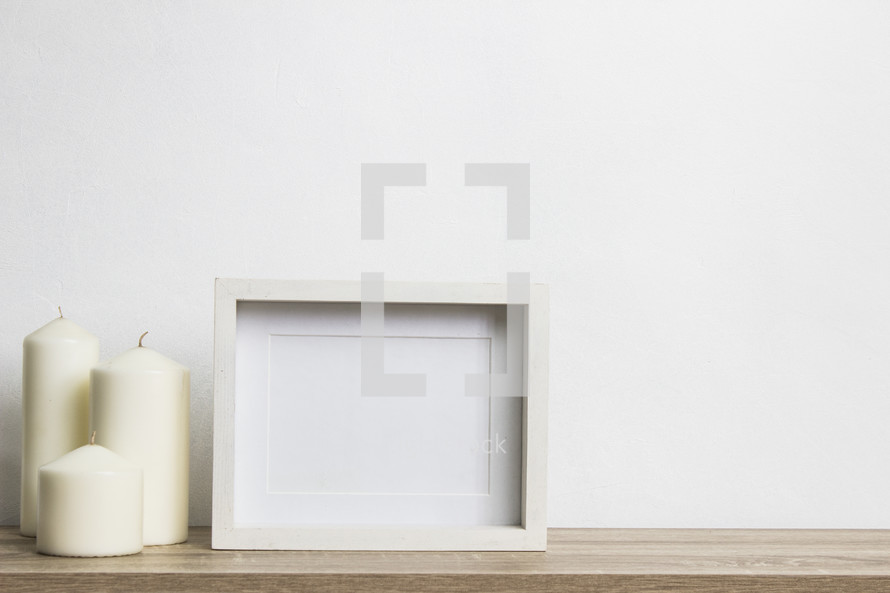 three candles and blank frame 