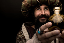 a wiseman holding a gift of myrrh 